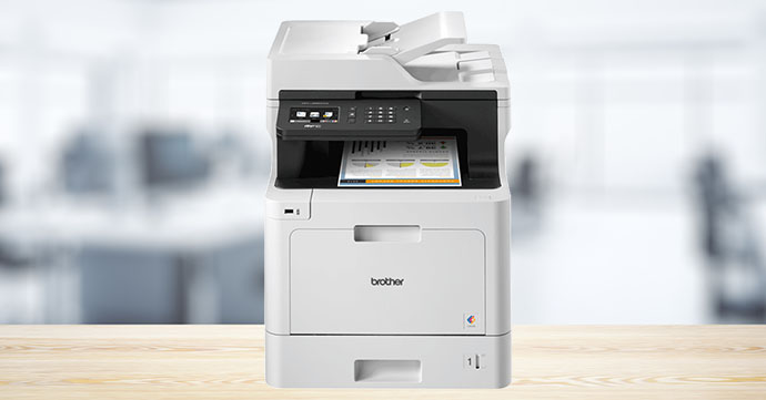 Brother MFC-L8690CDW Brother MFC-L8690CDW on light wood coloured desk