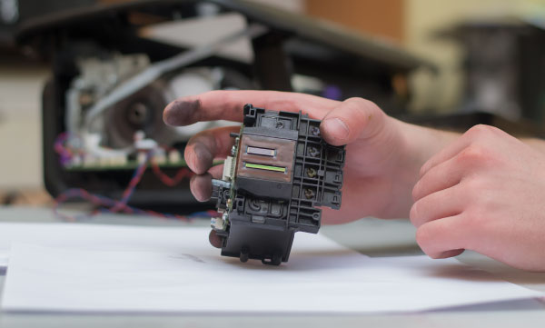 Printhead Print head held in hand on table being cleaning