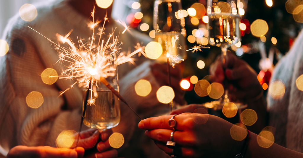 Festive Celebrations Partygoers holding glasses and sparklers.