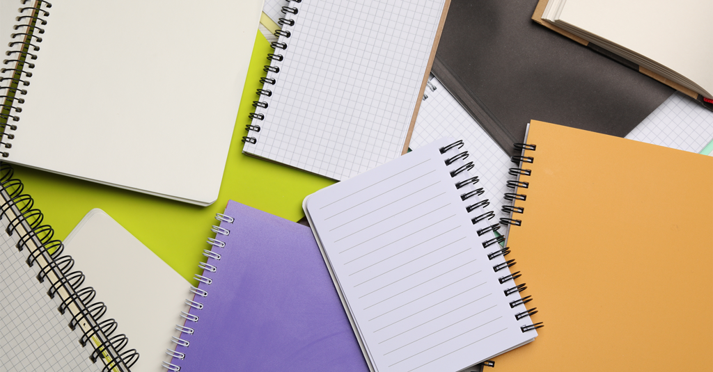 Notebooks spread out on a table.